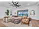 Bright living room features a large sectional sofa and access to a private patio at 5225 Caserta Ct, Palmetto, FL 34221