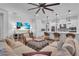 Open-concept living room and kitchen with hardwood floors and comfortable seating at 5225 Caserta Ct, Palmetto, FL 34221