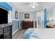 Bedroom with a dresser, a view of another room, and a blue door at 5401 Circle Dr, Weeki Wachee, FL 34607