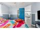 Bedroom with colorful bedding and view into dining area at 5401 Circle Dr, Weeki Wachee, FL 34607