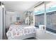 Bedroom with beach themed bedding and large window at 5401 Circle Dr, Weeki Wachee, FL 34607