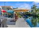 Relaxing waterfront patio with outdoor seating and umbrella at 5401 Circle Dr, Weeki Wachee, FL 34607