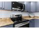 Kitchen with stainless steel stove and microwave at 5401 Circle Dr, Weeki Wachee, FL 34607