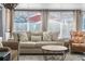 Living room with beige couch and patterned armchair at 5401 Circle Dr, Weeki Wachee, FL 34607