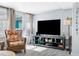 Living room with comfy chair and flat-screen TV at 5401 Circle Dr, Weeki Wachee, FL 34607