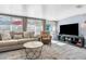 Cozy living room featuring a comfy sofa, armchair, and large TV at 5401 Circle Dr, Weeki Wachee, FL 34607