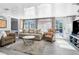Relaxing living room with sofa and wicker chair, access to backyard at 5401 Circle Dr, Weeki Wachee, FL 34607