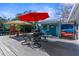 Outdoor patio furniture with red umbrella on a waterfront deck at 5401 Circle Dr, Weeki Wachee, FL 34607