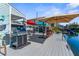 Large waterfront deck with a grill and outdoor seating area at 5401 Circle Dr, Weeki Wachee, FL 34607