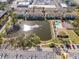 Aerial view of community pool, tennis courts and pond at 5705 80Th St N # 304, St Petersburg, FL 33709
