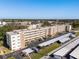An aerial view showcasing the condo building and its ample parking at 5705 80Th St N # 304, St Petersburg, FL 33709
