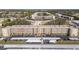 Aerial view of condo building with parking and surrounding landscape at 5705 80Th St N # 304, St Petersburg, FL 33709
