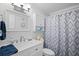 Bathroom with white vanity, shower, and patterned curtain at 5705 80Th St N # 304, St Petersburg, FL 33709