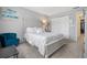 Bedroom with queen-size bed and teal accent chair at 5705 80Th St N # 304, St Petersburg, FL 33709