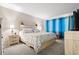 King-size bed, nightstands, and blue curtains at 5705 80Th St N # 304, St Petersburg, FL 33709