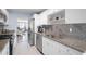 Modern kitchen with white cabinets and granite countertops at 5705 80Th St N # 304, St Petersburg, FL 33709