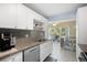 Modern kitchen with white cabinets and granite counters at 5705 80Th St N # 304, St Petersburg, FL 33709