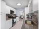Updated kitchen with white cabinets, granite counters, and stainless appliances at 5705 80Th St N # 304, St Petersburg, FL 33709