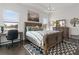 Main bedroom with a wooden sleigh bed, large windows, and a workspace at 5725 Stockport St, Riverview, FL 33578