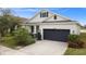 A charming house with a two-car garage, and a landscaped front yard at 5725 Stockport St, Riverview, FL 33578