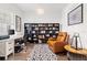 Home office with built-in bookshelves and a comfortable armchair at 5725 Stockport St, Riverview, FL 33578