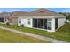 House with screened-in porch and lush green grass at 5725 Stockport St, Riverview, FL 33578