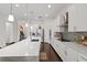 Modern kitchen featuring white cabinets, large island, and stainless steel appliances at 5725 Stockport St, Riverview, FL 33578