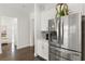 Open concept kitchen with stainless steel appliances and white cabinets at 5725 Stockport St, Riverview, FL 33578