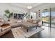 Relaxing living room with sectional sofa, ottoman, and access to a patio at 5725 Stockport St, Riverview, FL 33578