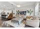 Cozy living room featuring a sectional sofa, ottoman, and wood floors at 5725 Stockport St, Riverview, FL 33578
