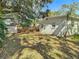 Large backyard with mature shade trees and a shed at 6002 N Ithmar Ave, Tampa, FL 33604