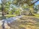 Renovated house with carport, landscaped yard, and brick walkway at 6002 N Ithmar Ave, Tampa, FL 33604