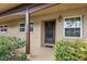 Inviting condo entryway with covered porch, lush landscaping, and a black front door at 601 N Hercules Ave # 503, Clearwater, FL 33765