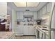 White kitchen cabinets, tile backsplash, and stainless steel appliances at 601 N Hercules Ave # 503, Clearwater, FL 33765