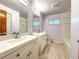 Updated bathroom featuring double sinks, tile flooring, and a shower/tub combination at 6700 Turner N St, St Petersburg, FL 33702