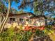 The rear exterior of this home features a patio, lush landscaping, and a detached garage at 6700 Turner N St, St Petersburg, FL 33702