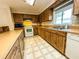 Traditional kitchen with wood cabinets, countertops, white appliances, and a window above the sink at 6700 Turner N St, St Petersburg, FL 33702
