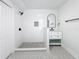 Modern bathroom with walk-in shower, patterned tile floor, and white vanity at 718 34Th S Ave, St Petersburg, FL 33705