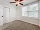 Bright bedroom with carpet flooring, double door closet, and window with blinds at 718 34Th S Ave, St Petersburg, FL 33705