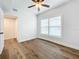 Charming bedroom with hardwood floors, ceiling fan, and access to a bathroom at 718 34Th S Ave, St Petersburg, FL 33705