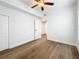Well-lit bedroom featuring hardwood floors, a ceiling fan, and an ensuite bathroom at 718 34Th S Ave, St Petersburg, FL 33705