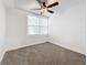 Spacious bedroom with ceiling fan, neutral walls and gray carpeting at 718 34Th S Ave, St Petersburg, FL 33705