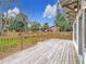 Wooden deck with railing, overlooking backyard, and neighboring houses at 718 34Th S Ave, St Petersburg, FL 33705
