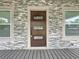 Modern front door with glass panels and stone surround at 718 34Th S Ave, St Petersburg, FL 33705