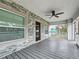 Grey porch with ceiling fan, stone feature wall and view of yard at 718 34Th S Ave, St Petersburg, FL 33705