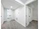 Bright hallway with gray carpet and white walls, leading to bedrooms and other rooms at 718 34Th S Ave, St Petersburg, FL 33705