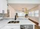 Modern kitchen with white cabinets, quartz countertops and stainless steel appliances at 718 34Th S Ave, St Petersburg, FL 33705