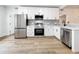 Modern kitchen with stainless steel appliances and white cabinets at 718 34Th S Ave, St Petersburg, FL 33705