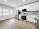 Modern kitchen with stainless steel appliances and white cabinets at 718 34Th S Ave, St Petersburg, FL 33705