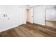 Bright laundry room with wood floors, built-in shelving and door to another room at 718 34Th S Ave, St Petersburg, FL 33705